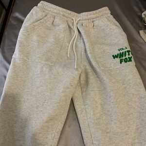 white fox cuffed sweats with green lettering size xs
